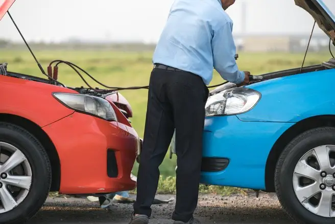 helping to charge an automotive from another vehicle connecting the charger