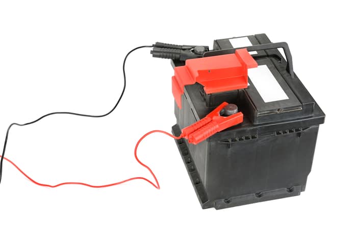 How can you use a trickle charger to charge a dead car battery?